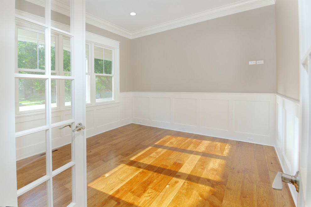 Ejemplo de despacho tradicional con paredes grises, suelo de madera en tonos medios y suelo marrón