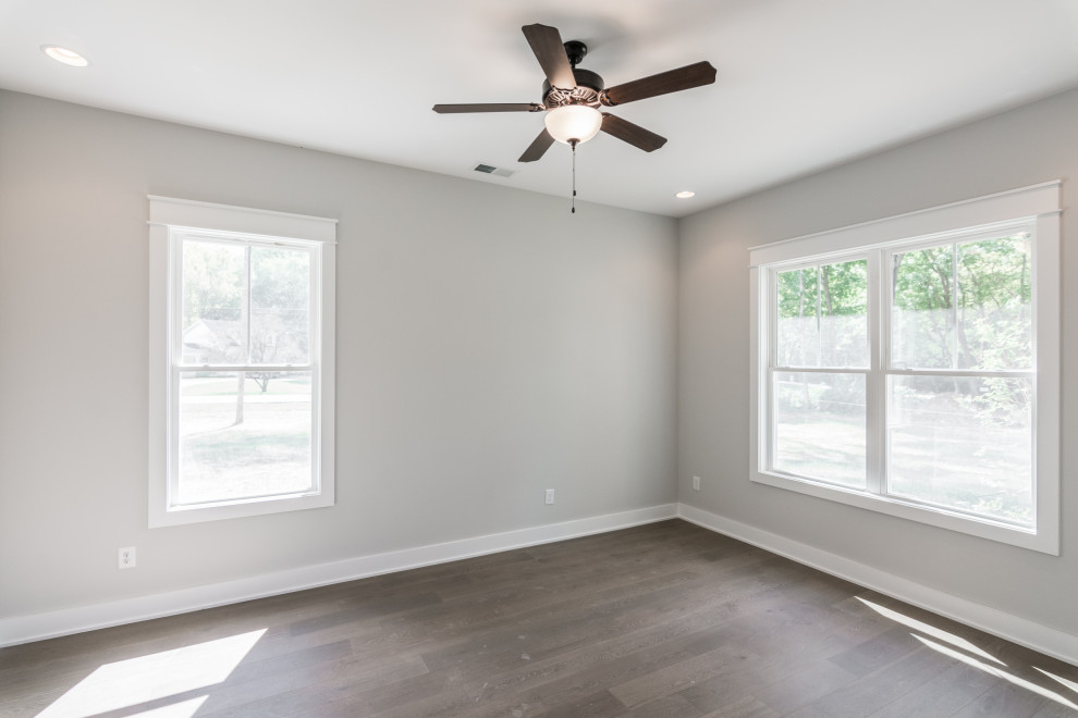 Large country vinyl floor and brown floor home office photo in Nashville with gray walls and no fireplace