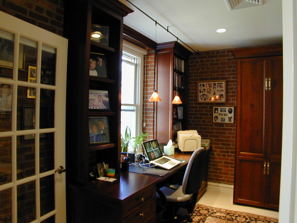 This is an example of a medium sized traditional study in Boston with red walls, porcelain flooring, no fireplace, a built-in desk and white floors.