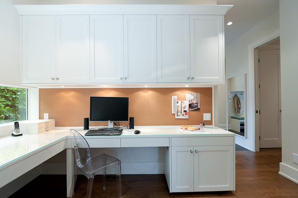 Example of a transitional home office design in Vancouver
