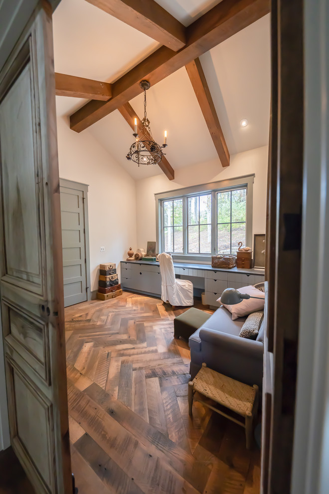 Rural study in Other with white walls, medium hardwood flooring and a built-in desk.