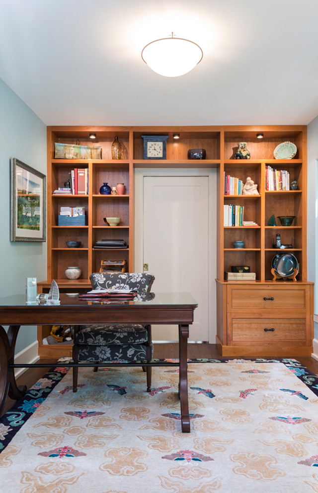 Small elegant freestanding desk dark wood floor and brown floor study room photo in Detroit with blue walls and no fireplace