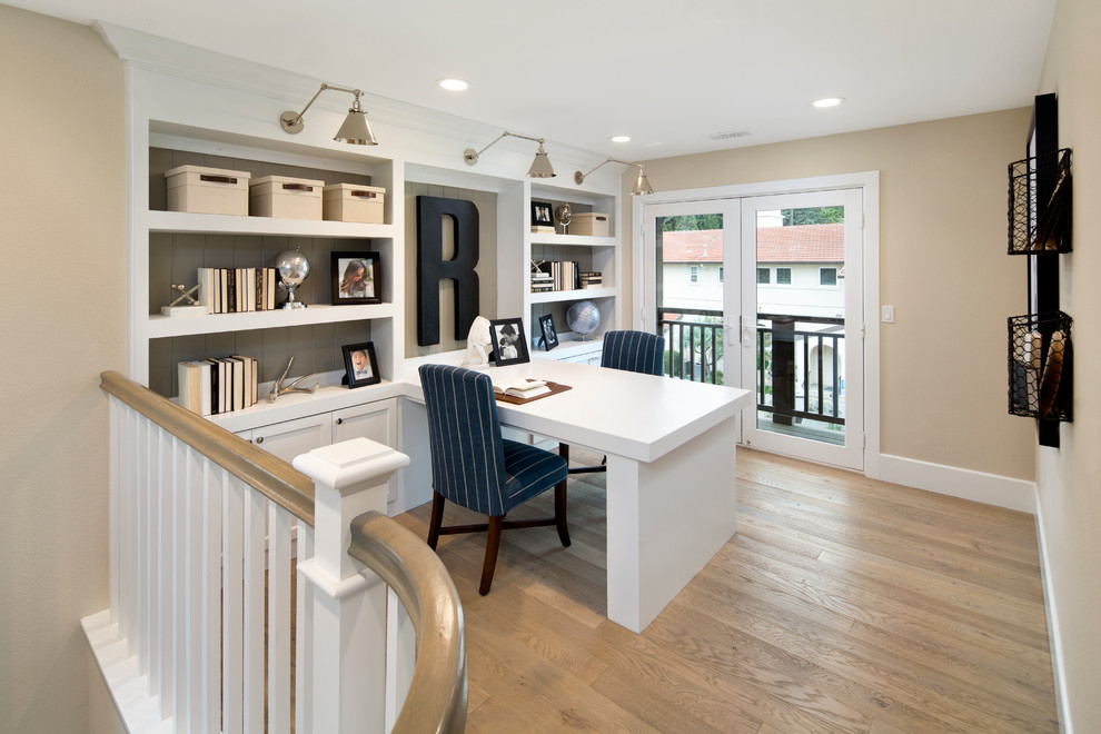 Inspiration for a classic study in San Francisco with beige walls, light hardwood flooring and a built-in desk.