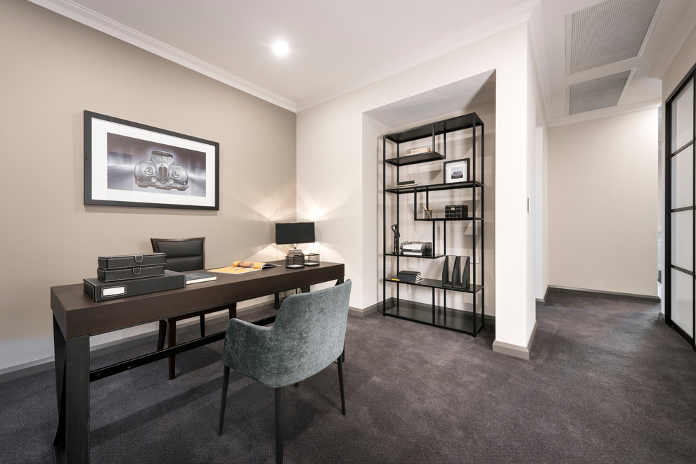 Modernes Arbeitszimmer mit Arbeitsplatz, beiger Wandfarbe, Teppichboden, freistehendem Schreibtisch und grauem Boden in Perth