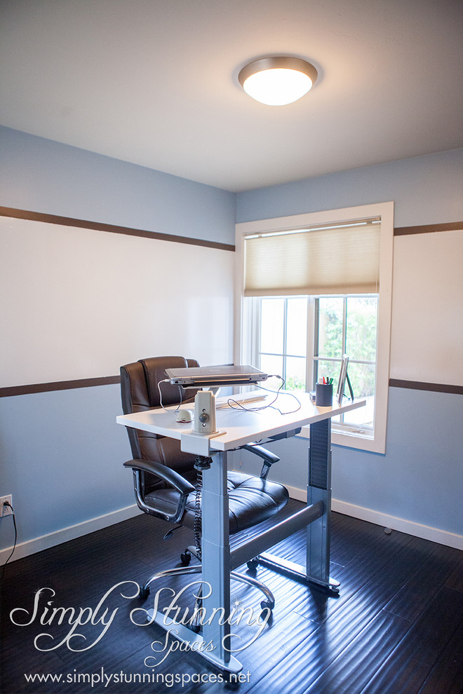 Small contemporary study in San Diego with blue walls, dark hardwood flooring, no fireplace and a freestanding desk.
