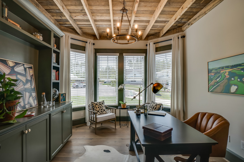 This is an example of a medium sized rustic home office in Richmond with white walls, medium hardwood flooring, no fireplace, a freestanding desk and brown floors.