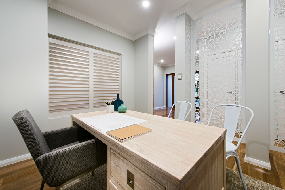 Mittelgroßes Modernes Arbeitszimmer ohne Kamin mit Arbeitsplatz, grauer Wandfarbe, braunem Holzboden und freistehendem Schreibtisch in Perth