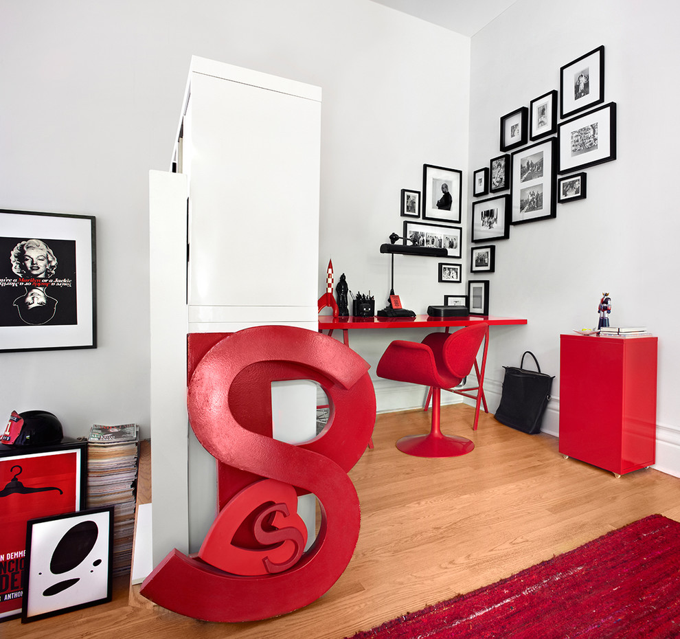 This is an example of a contemporary home office in Dallas with white walls, medium hardwood flooring and a freestanding desk.