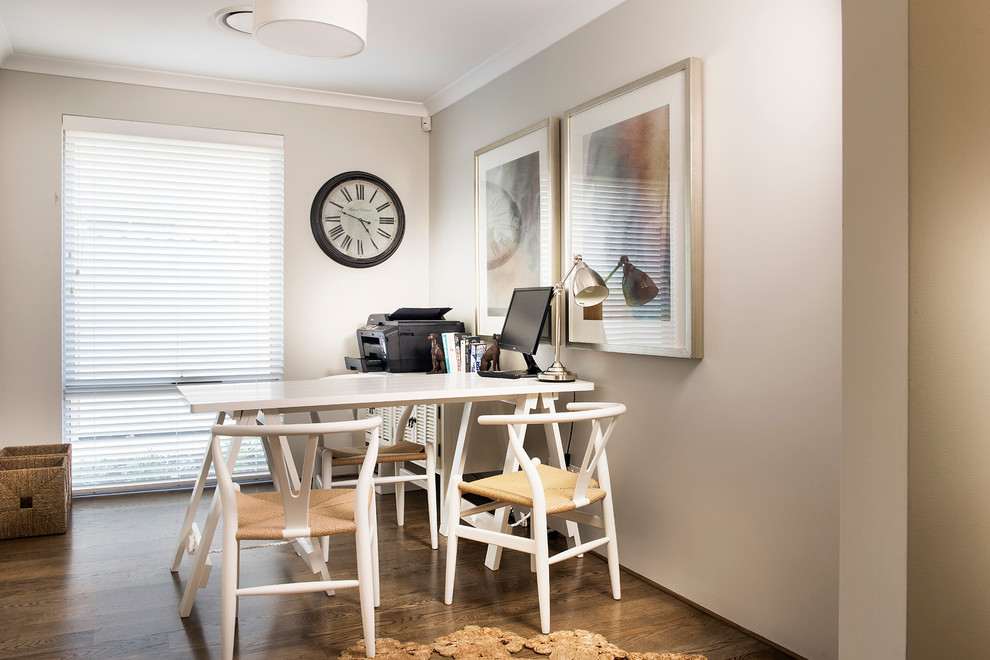 This is an example of a contemporary home office in Perth with grey walls, medium hardwood flooring and a freestanding desk.