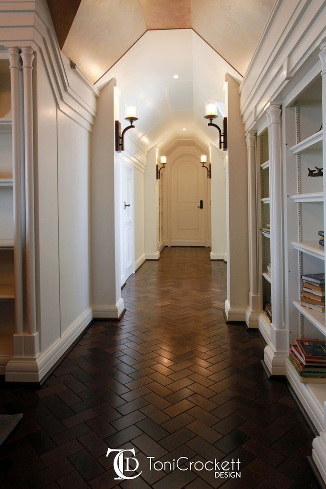 This is an example of an expansive victorian study in Other with white walls and a built-in desk.