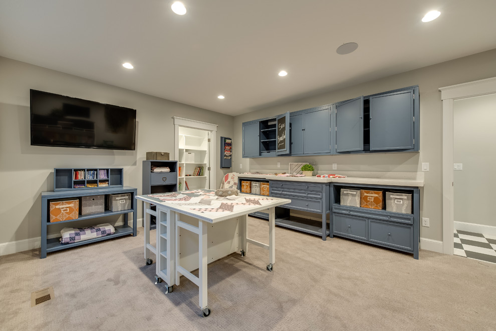 Large traditional craft room in Salt Lake City with grey walls, carpet, no fireplace, a built-in desk and beige floors.