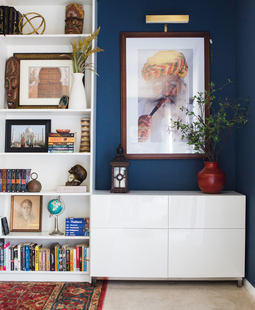 Trendy freestanding desk home office photo in New York with blue walls