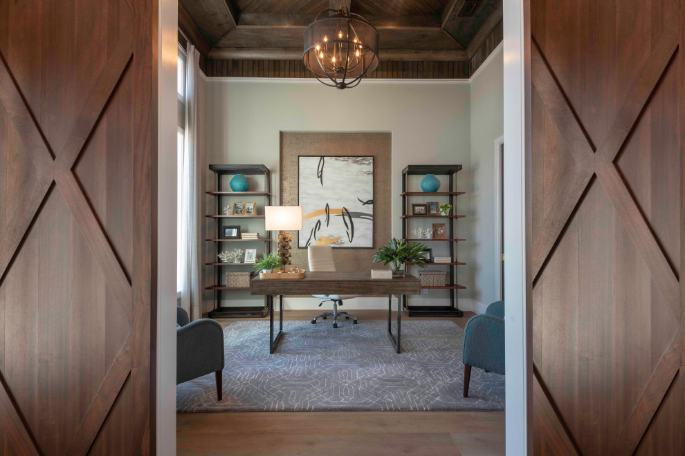 Design ideas for a traditional home office in Tampa with grey walls, medium hardwood flooring, a freestanding desk and brown floors.