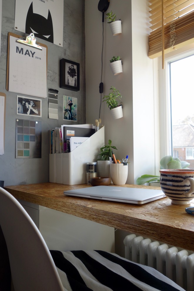 Modelo de despacho industrial pequeño sin chimenea con paredes grises y escritorio independiente