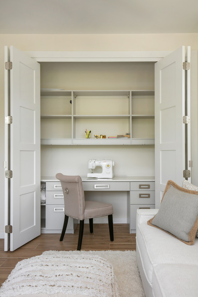 Ispirazione per una stanza da lavoro moderna di medie dimensioni con pareti bianche, pavimento in gres porcellanato, scrivania autoportante e pavimento marrone