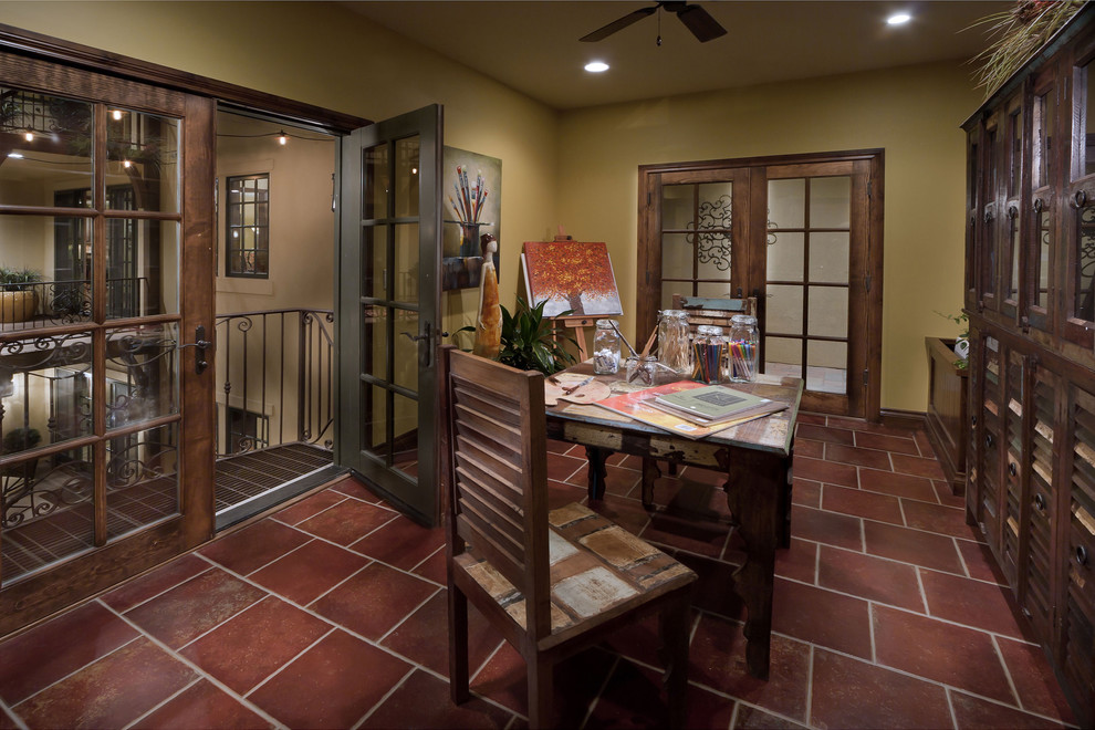 Example of a tuscan freestanding desk home studio design in Denver with green walls