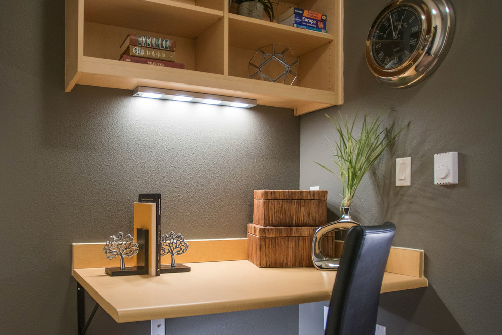 This is an example of a small contemporary home office in Seattle with brown walls and a built-in desk.