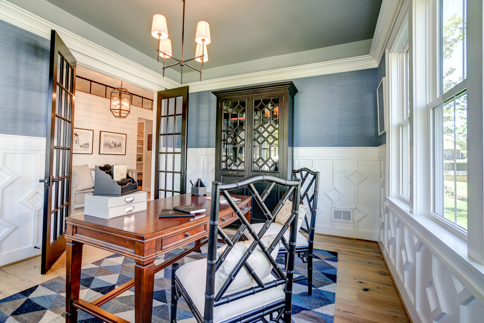 Imagen de despacho de estilo de casa de campo de tamaño medio con paredes azules, suelo de madera clara, escritorio independiente y suelo marrón