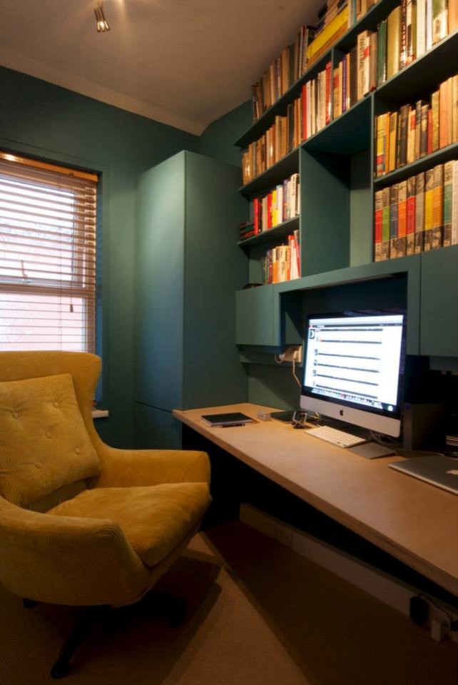 Small trendy built-in desk carpeted study room photo in Manchester with blue walls and no fireplace