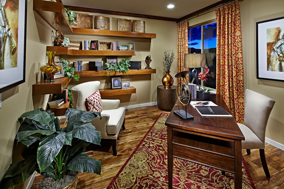 Modelo de despacho tradicional con paredes beige, suelo de madera oscura y escritorio independiente
