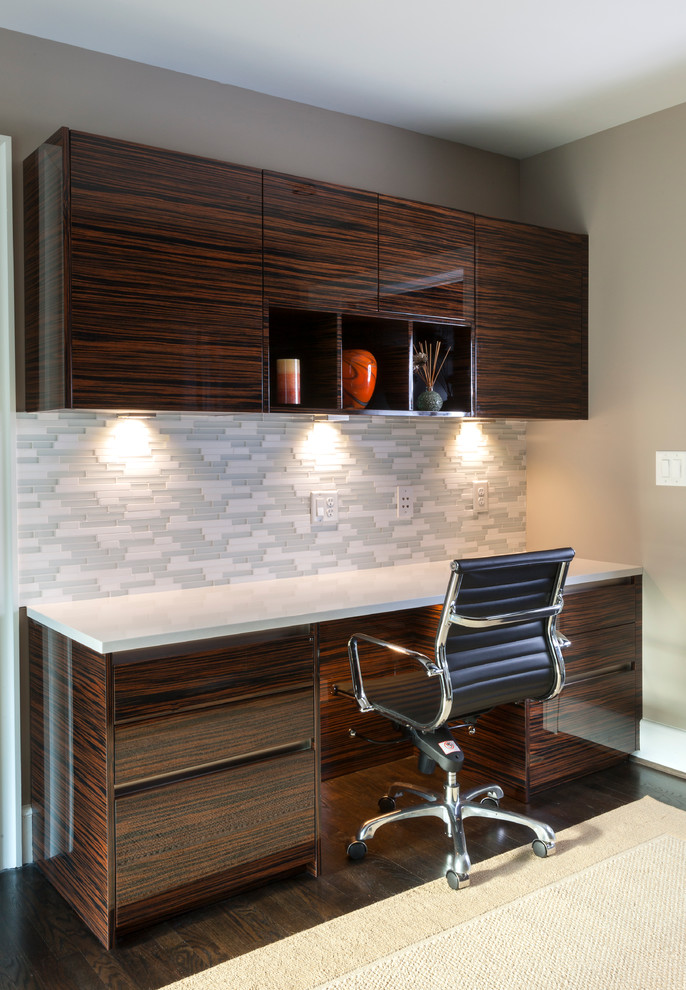 Study room - mid-sized contemporary built-in desk dark wood floor study room idea in Charlotte with beige walls
