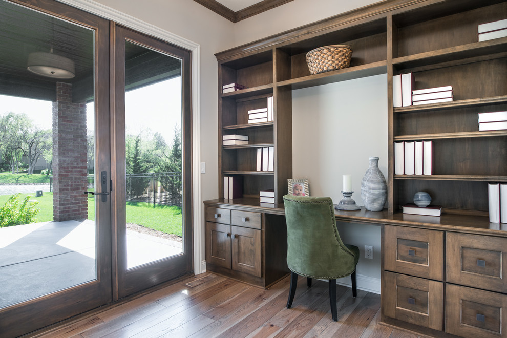 Design ideas for a medium sized traditional home office in Wichita with beige walls, medium hardwood flooring and a built-in desk.