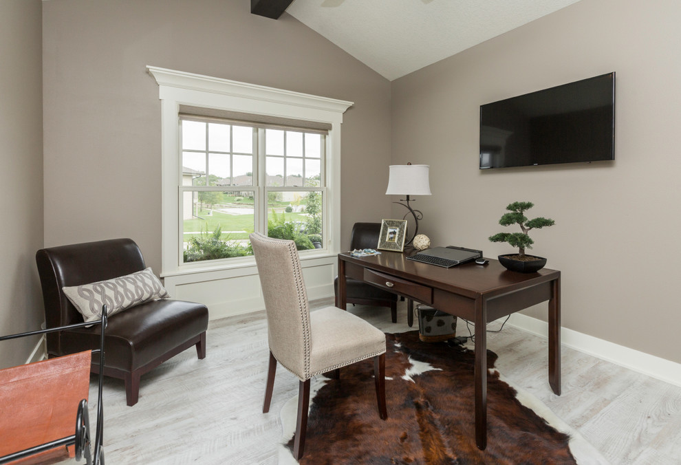 Small traditional study in Other with grey walls, light hardwood flooring, no fireplace, a freestanding desk and grey floors.