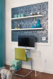 blue botanical print wallpaper in a frame behind a shelf above a desk