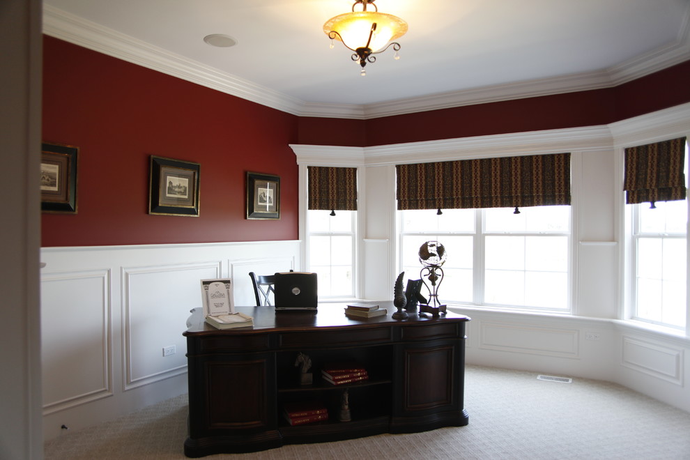 Foto di un grande ufficio tradizionale con pareti rosse, moquette e scrivania autoportante