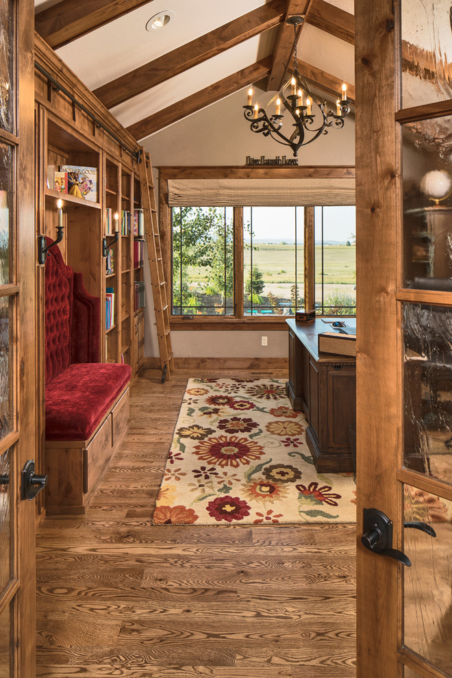 Imagen de despacho rural con paredes beige, suelo de madera en tonos medios, escritorio independiente y suelo marrón
