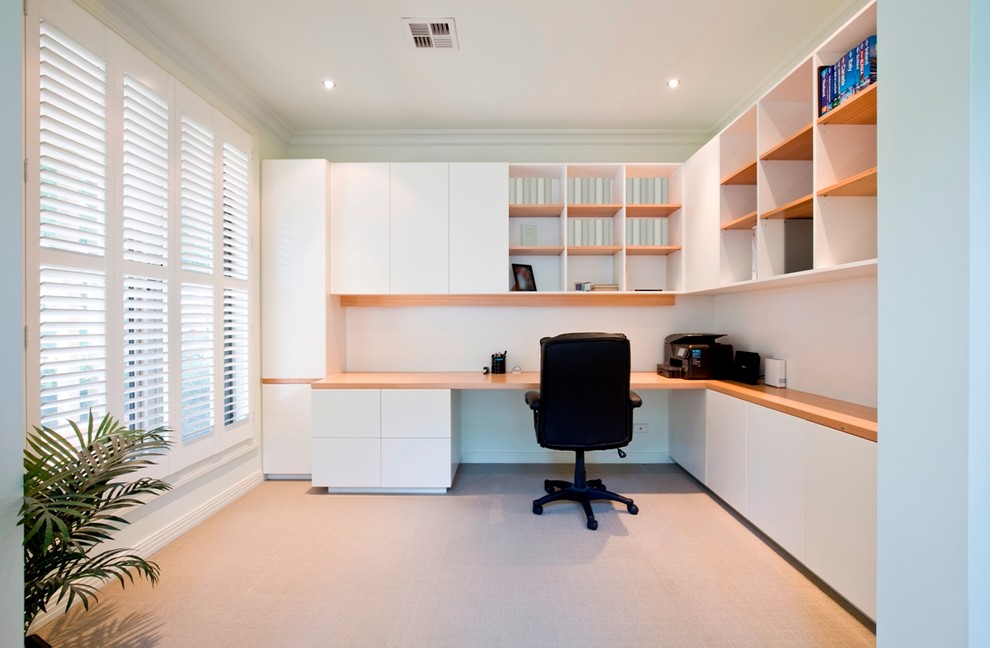 Inspiration for a large contemporary home office in Melbourne with white walls, carpet and a built-in desk.