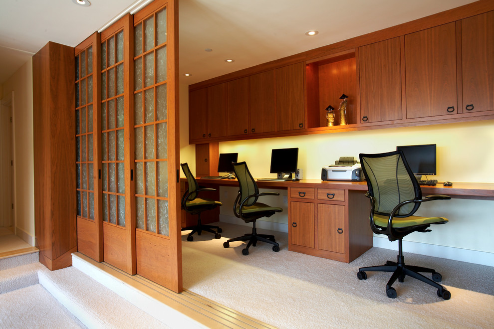 Photo of a medium sized world-inspired study in San Francisco with white walls, carpet, no fireplace and a built-in desk.