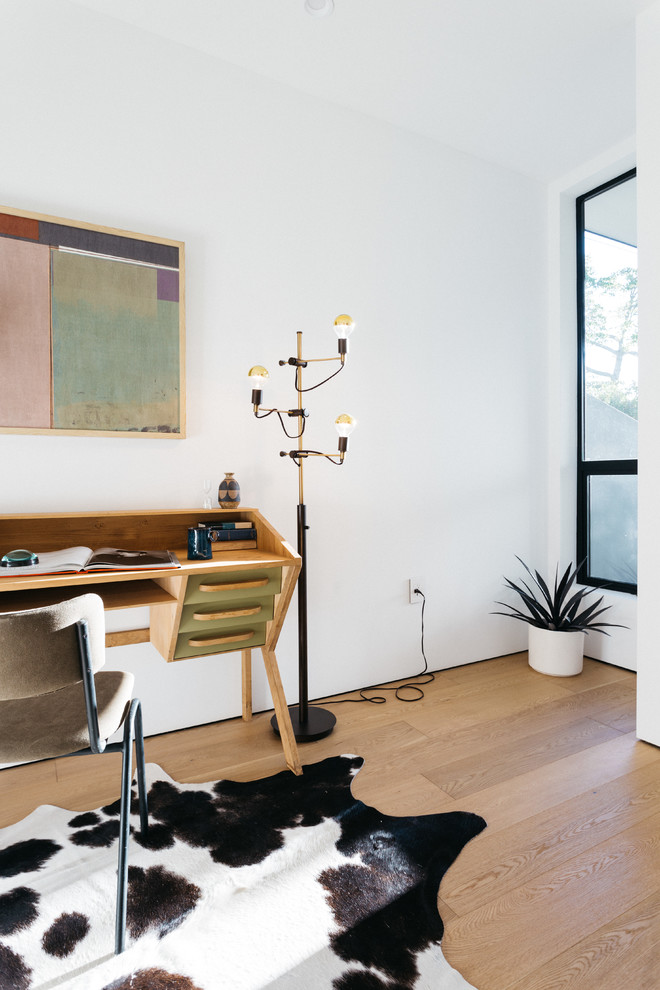 Small minimalist freestanding desk light wood floor study room photo in Los Angeles with white walls