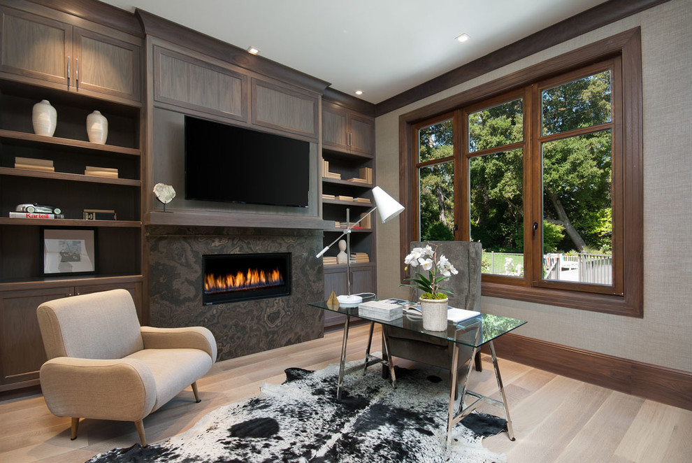 Traditional study in San Francisco with light hardwood flooring, a ribbon fireplace, a freestanding desk, beige floors and grey walls.