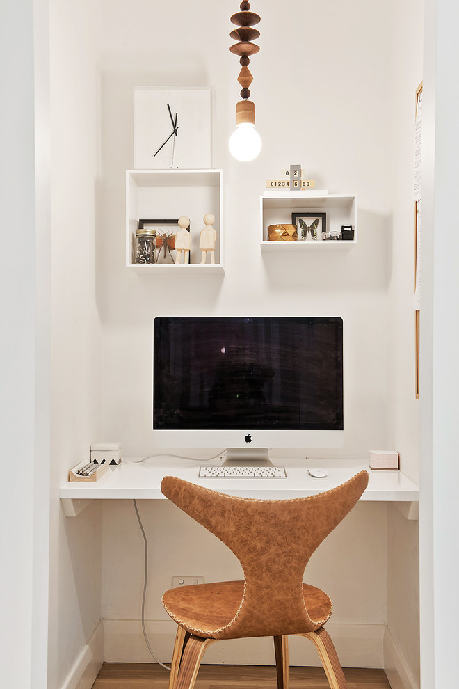 Small contemporary study in Adelaide with white walls, light hardwood flooring and a built-in desk.