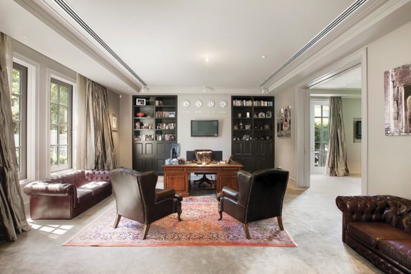 Example of a huge classic freestanding desk carpeted and gray floor study room design in Melbourne with gray walls, a standard fireplace and a metal fireplace