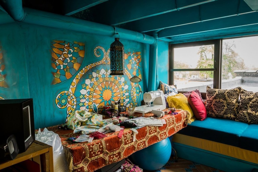 Inspiration för ett eklektiskt hobbyrum, med blå väggar och ett fristående skrivbord