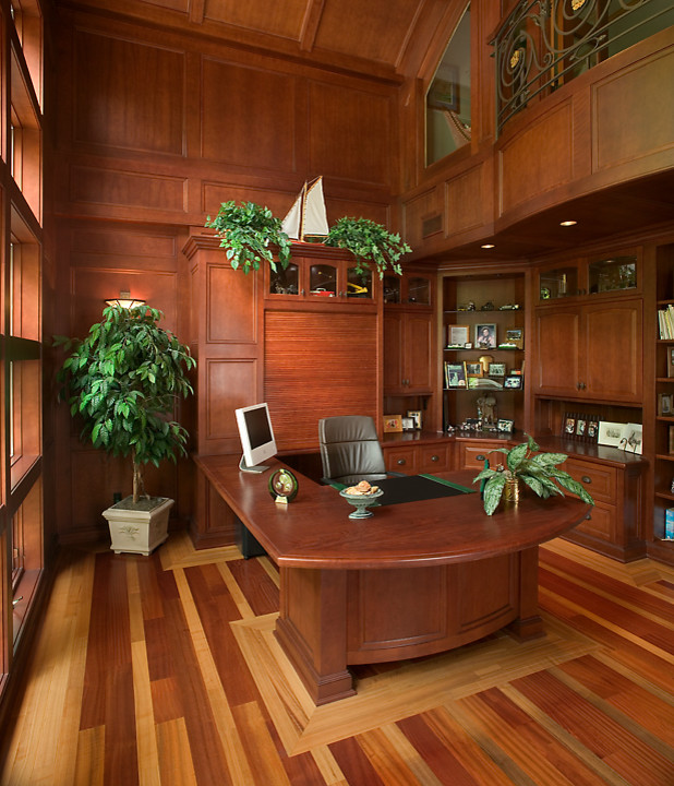 Example of a huge classic built-in desk medium tone wood floor study room design in Grand Rapids with brown walls