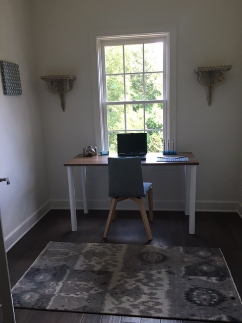 Study room - mid-sized contemporary freestanding desk dark wood floor study room idea in Charlotte with gray walls