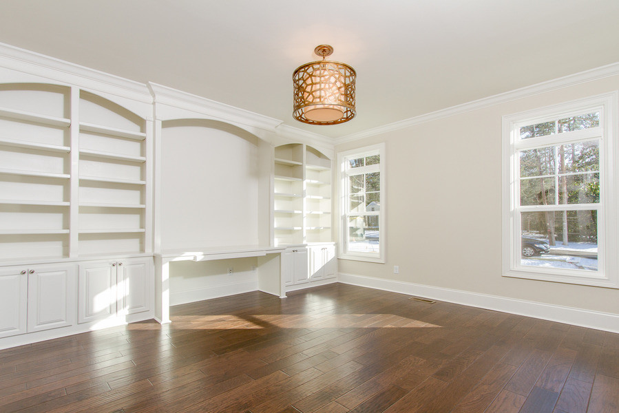 Medium sized classic home office in Raleigh with beige walls, dark hardwood flooring, no fireplace and a built-in desk.