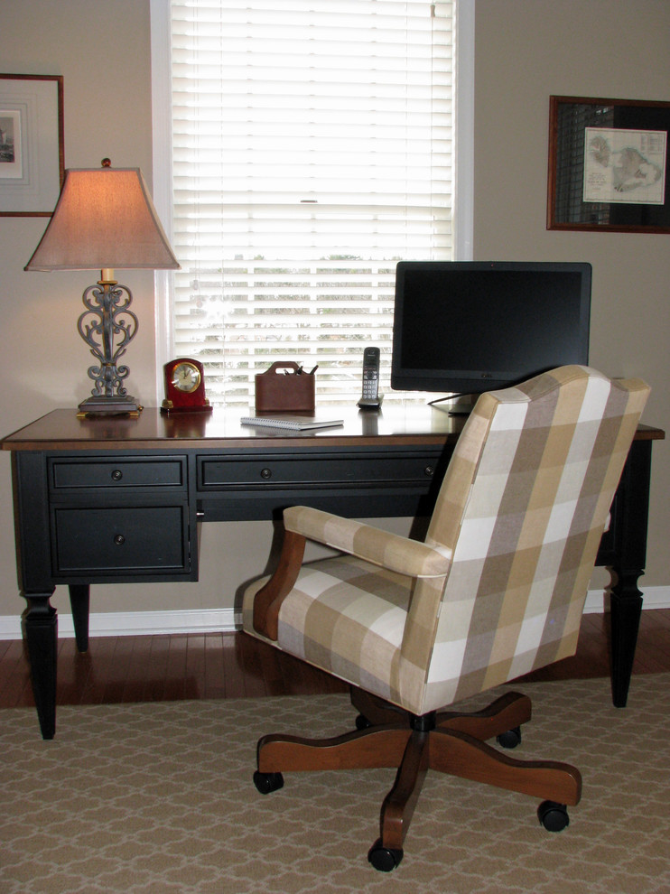This is an example of a medium sized traditional home office in Philadelphia with beige walls and a freestanding desk.