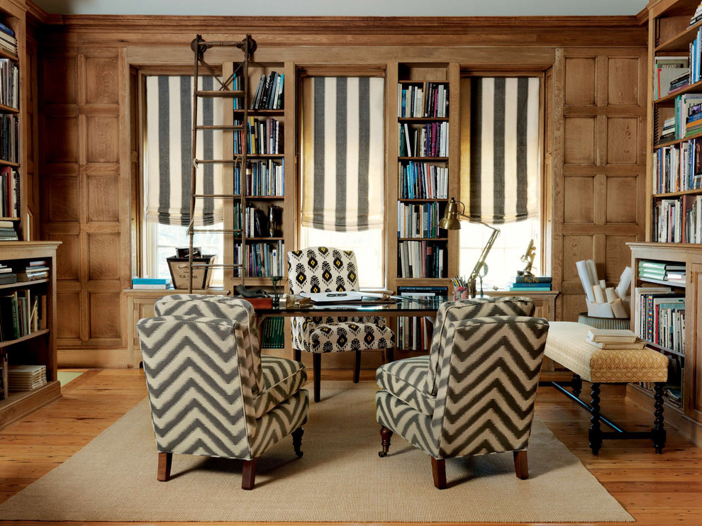 Traditional home office in Other with medium hardwood flooring and a freestanding desk.