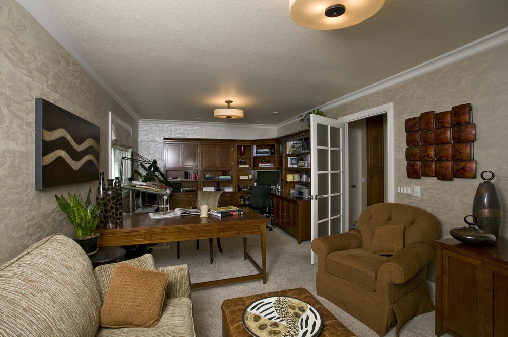 Example of a mid-sized classic freestanding desk carpeted study room design in Orange County with beige walls and no fireplace