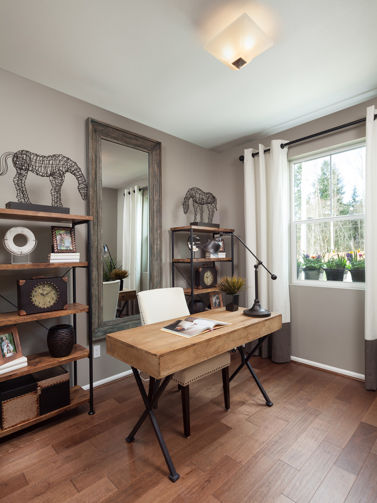 Klassisches Arbeitszimmer mit Arbeitsplatz, grauer Wandfarbe, freistehendem Schreibtisch und braunem Holzboden in Seattle