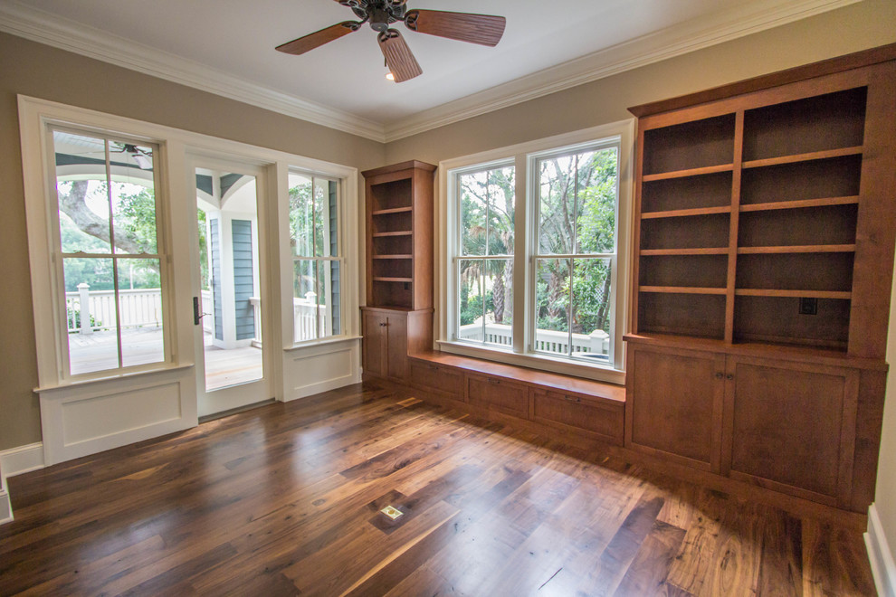 Example of a mid-sized classic freestanding desk dark wood floor study room design in Charleston with beige walls