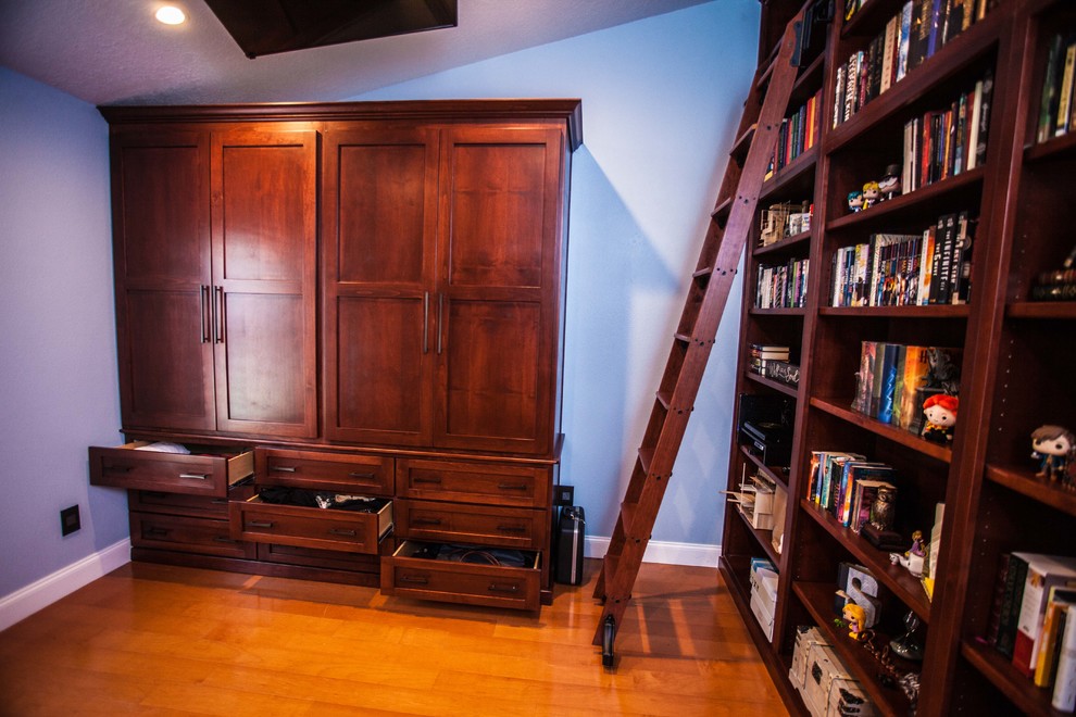 Photo of a medium sized traditional home office in Orlando with a reading nook, blue walls, medium hardwood flooring, no fireplace, a built-in desk and brown floors.