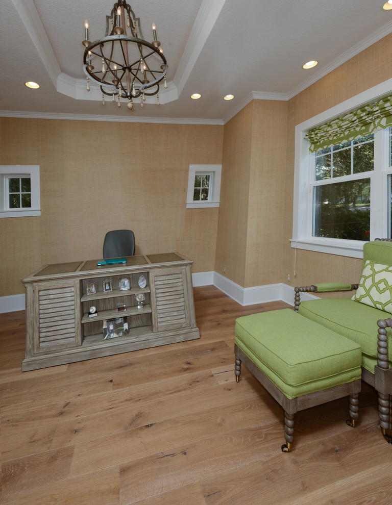 Photo of a large rustic home office in Tampa with beige walls and light hardwood flooring.