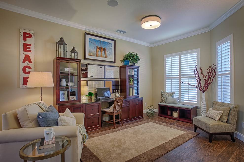 This is an example of a medium sized classic home office in Orlando with beige walls and a freestanding desk.