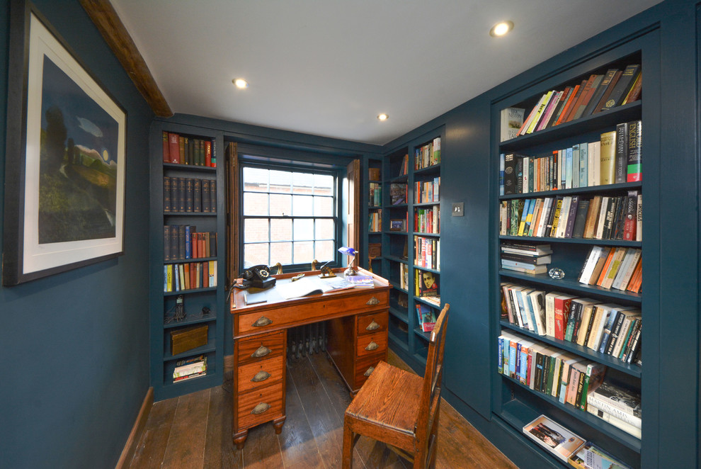 Small rural study in Kent with blue walls, dark hardwood flooring, no fireplace and a freestanding desk.