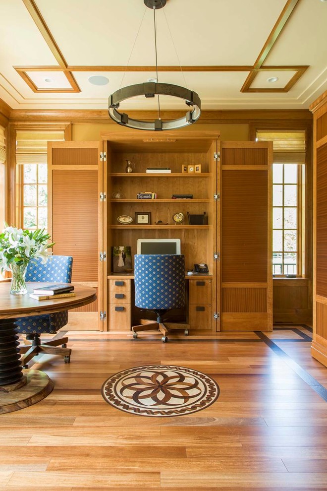 Home office - craftsman built-in desk medium tone wood floor home office idea in DC Metro with beige walls and no fireplace
